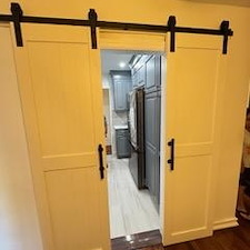 We-Transformed-a-tiny-Galley-Kitchen-in-Astoria-Queens-using-Barn-doors-to-create-more-of-an-open-concept 1